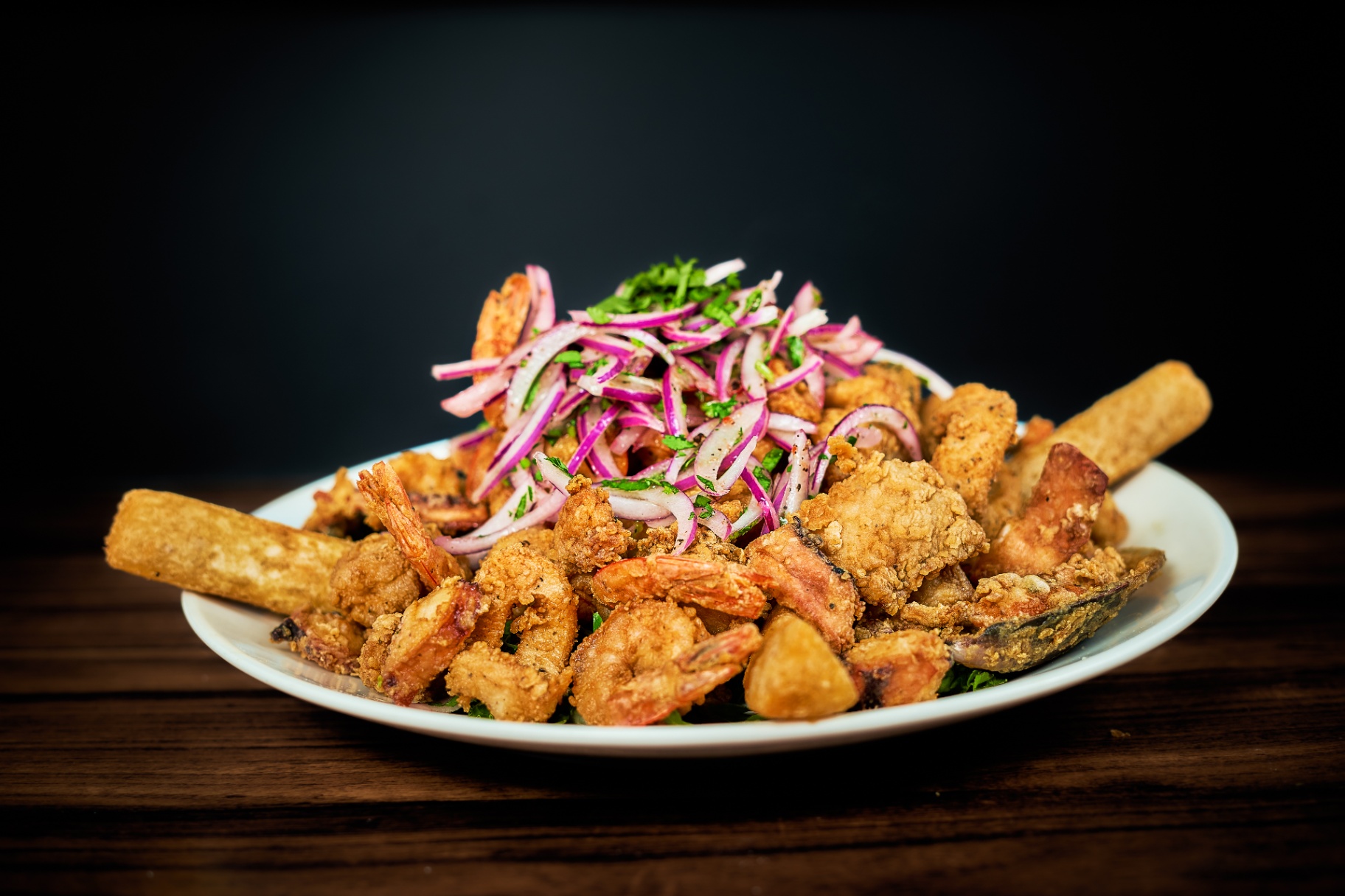 Crispy seafood platter with red onion salad