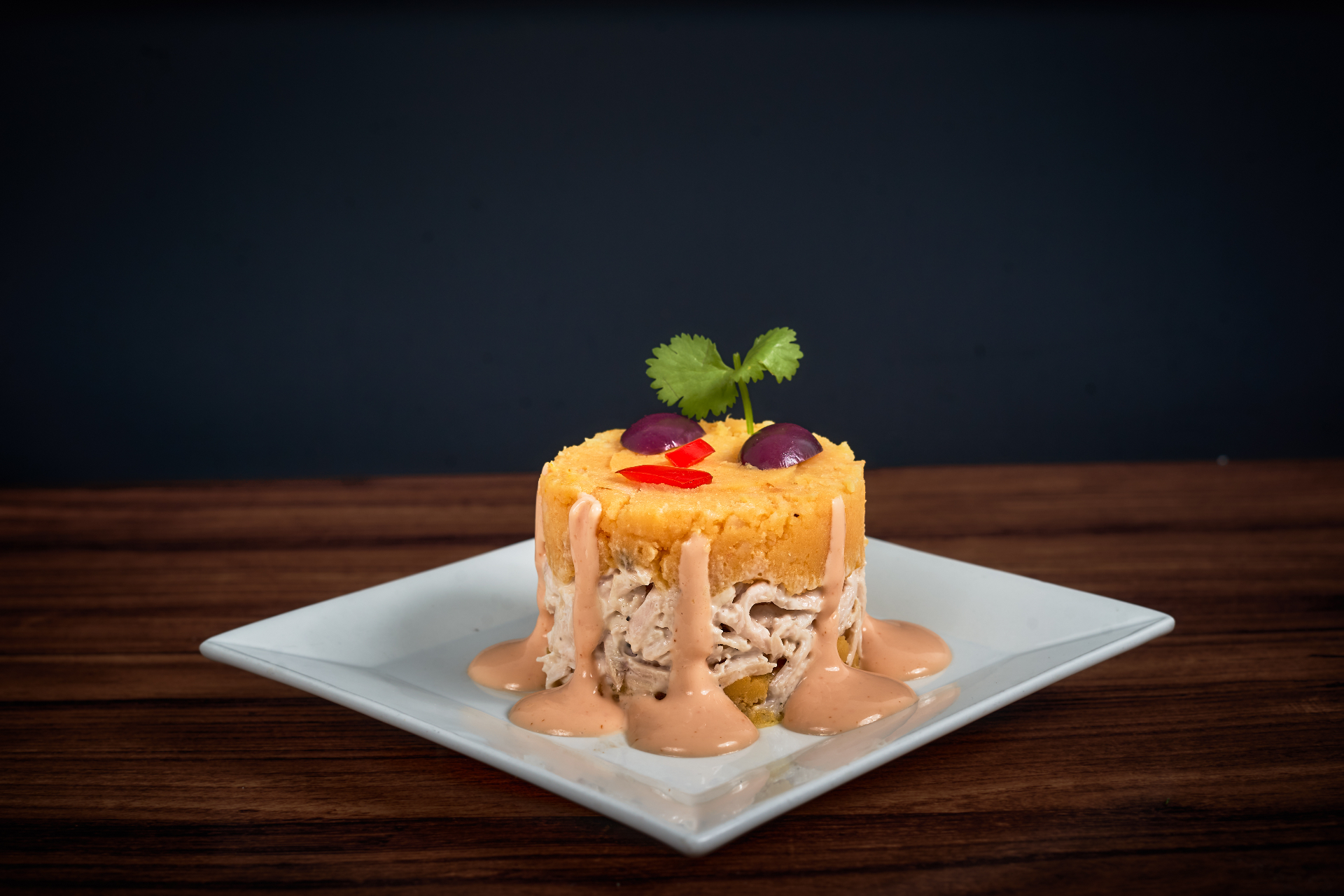 Causa rellena plated as a layered Peruvian appetizer