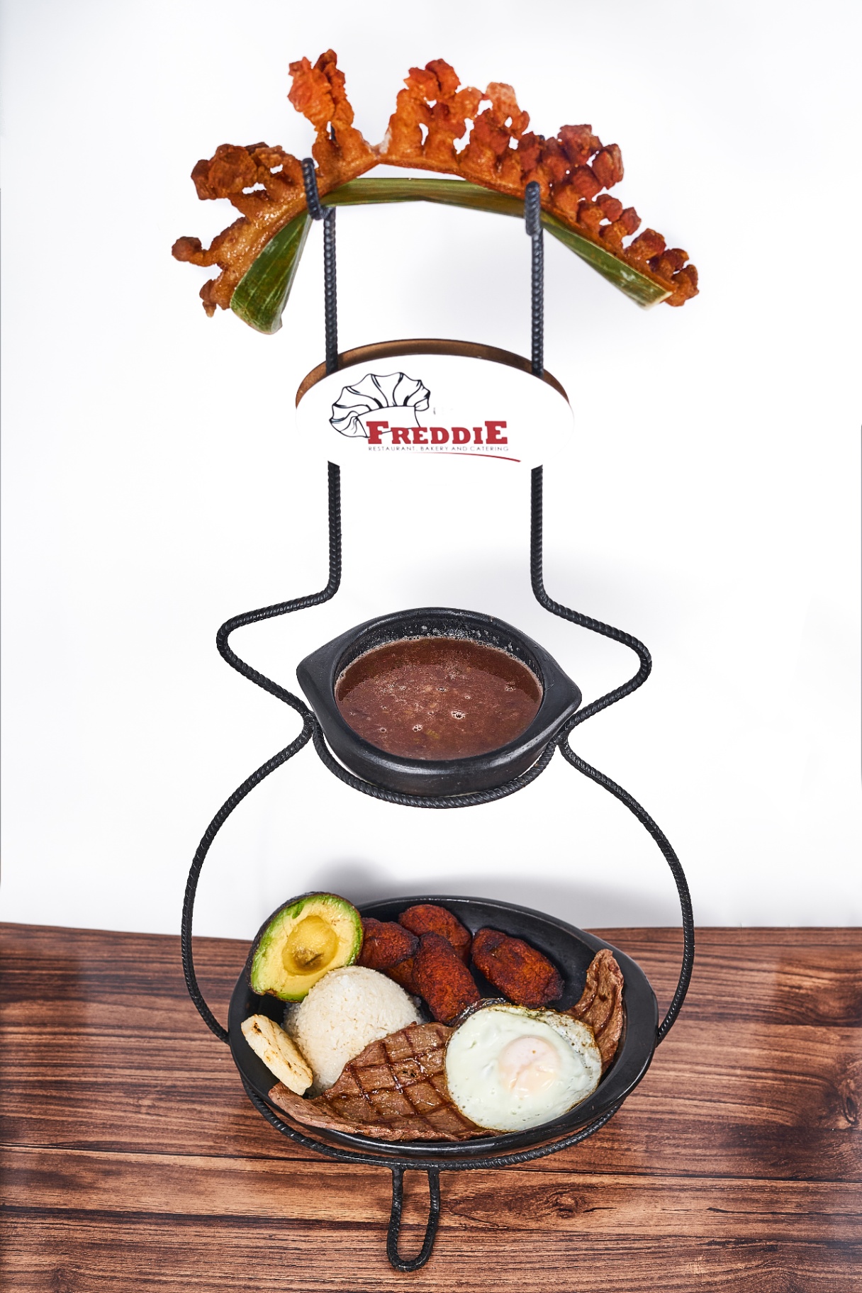 Bandeja paisa served with beans, rice, egg, avocado and meats
