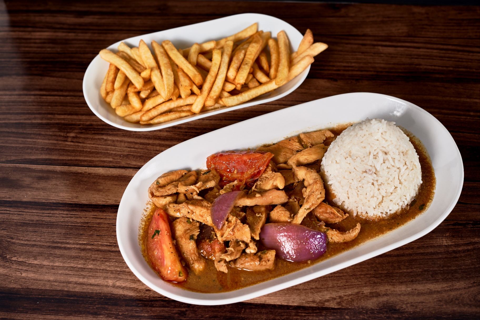 Pollo saltado with rice and fries